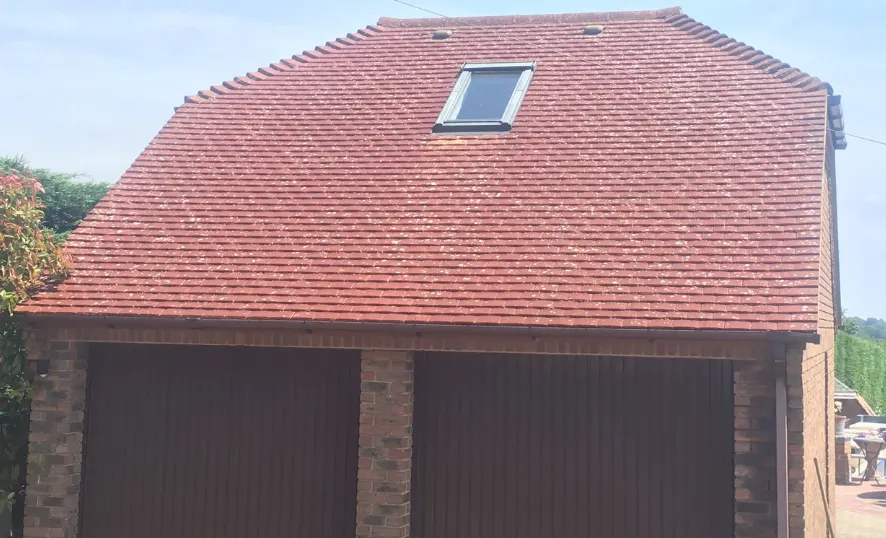 The same garage roof back to red tiles after cleaning