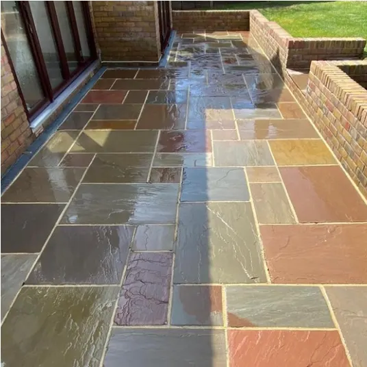 The same patio after pressure washing, colour back in the stone