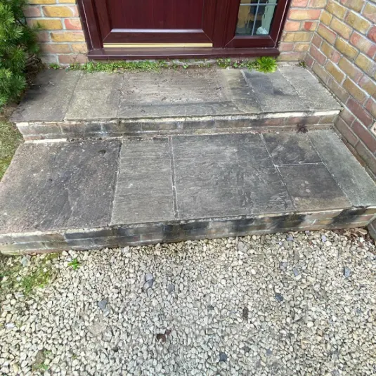 Grey, weathered front steps before cleaning